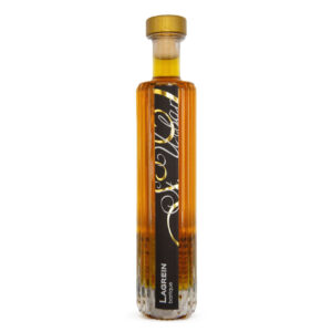 Bottle of St. Urban Lagrein Barrique, an amber-colored spirit, sealed with a gold-topped cork.
