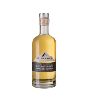 Bottle of Felsenriss Enzianschnaps Amaro Alla Genziana, a clear golden liquor.