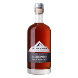 Bottle of Feuerwasser Spezie Infuocate liquor from Felsenriss Distillery, with a cork and aluminum seal.