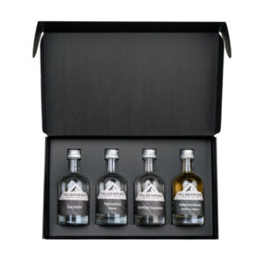 Open gift box containing four mini bottles of Felsenriss schnapps, each a different flavor.